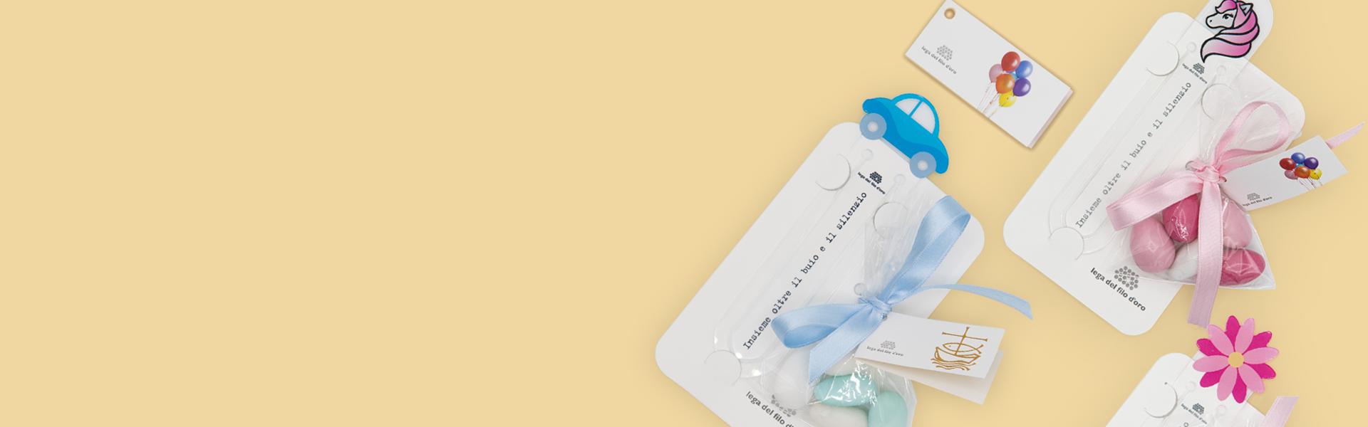 Composizione di bomboniere per comunione su sfondo giallo, con bomboniere unicorno, automobile e fiore, perfette per celebrare questo importante sacramento con eleganza e stile.