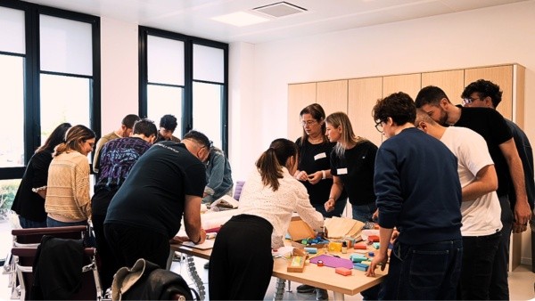 Alcuni dipendenti della Simonelli Group sono attorno ad un tavolo, nel mentre che svolgono le attività del Volontariato d'Impresa presso il Centro Nazionale di Osimo