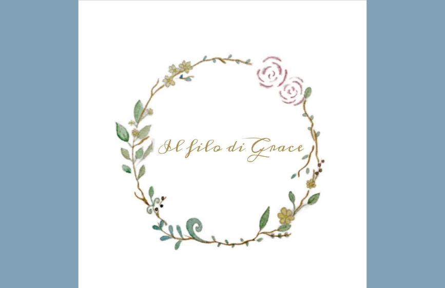 logo con la scritta "Il filo di Grace" in un font corsivo dorato, circondato da una ghirlanda acquerellata di foglie verdi e piccoli fiori rosa e gialli, su uno sfondo bianco.