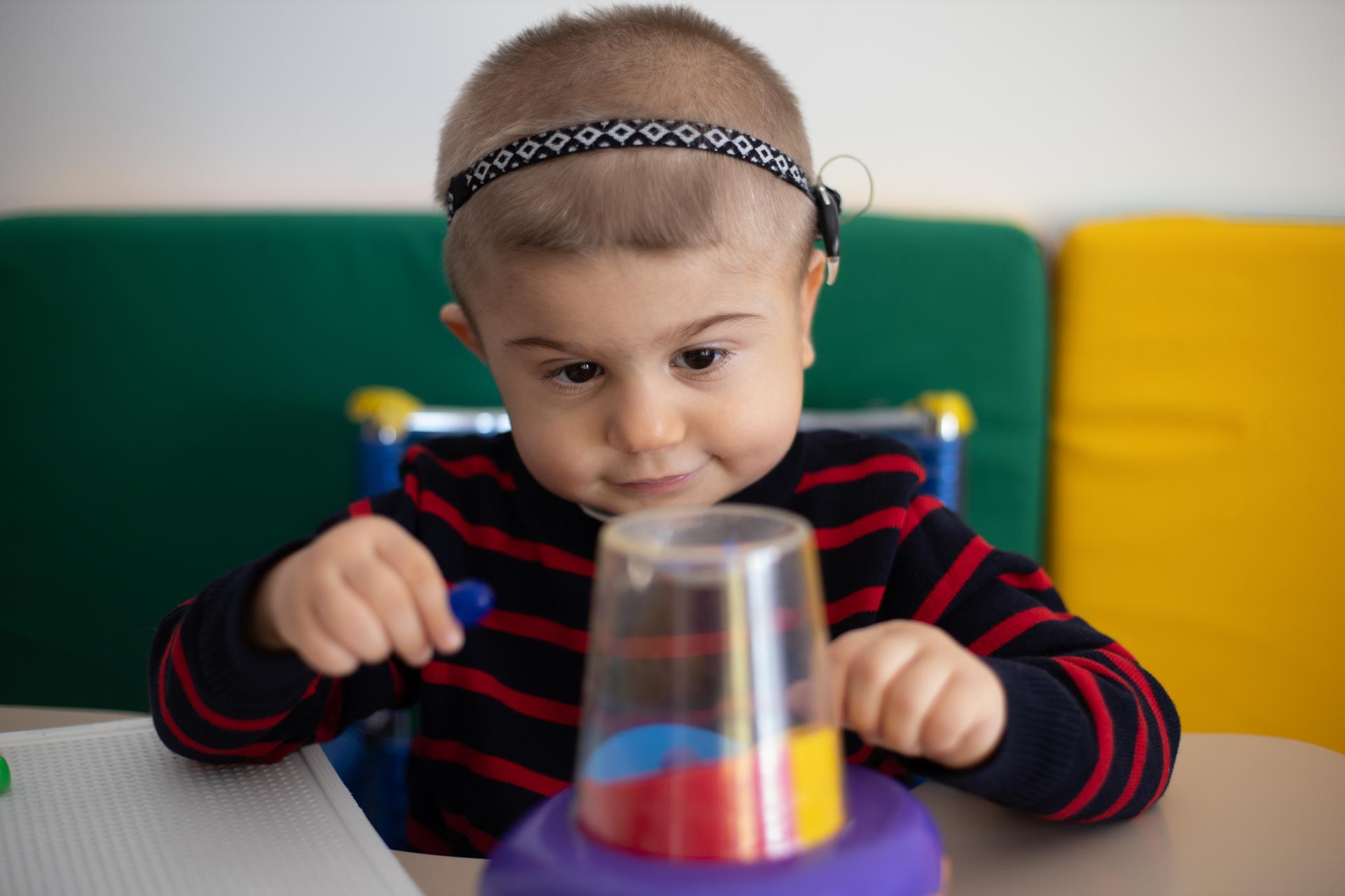 Berkay, bambino con la sindrome di Charge, seguito dalla Lega del Filo d'Oro, si trova nell'aula del Centro Nazionale seduto a giocare