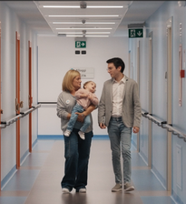 Un educatrice con la bambina Benedetta e Luca, un nostro sostenitore, che camminano nei corridoi del Centro Nazionale di Osimo