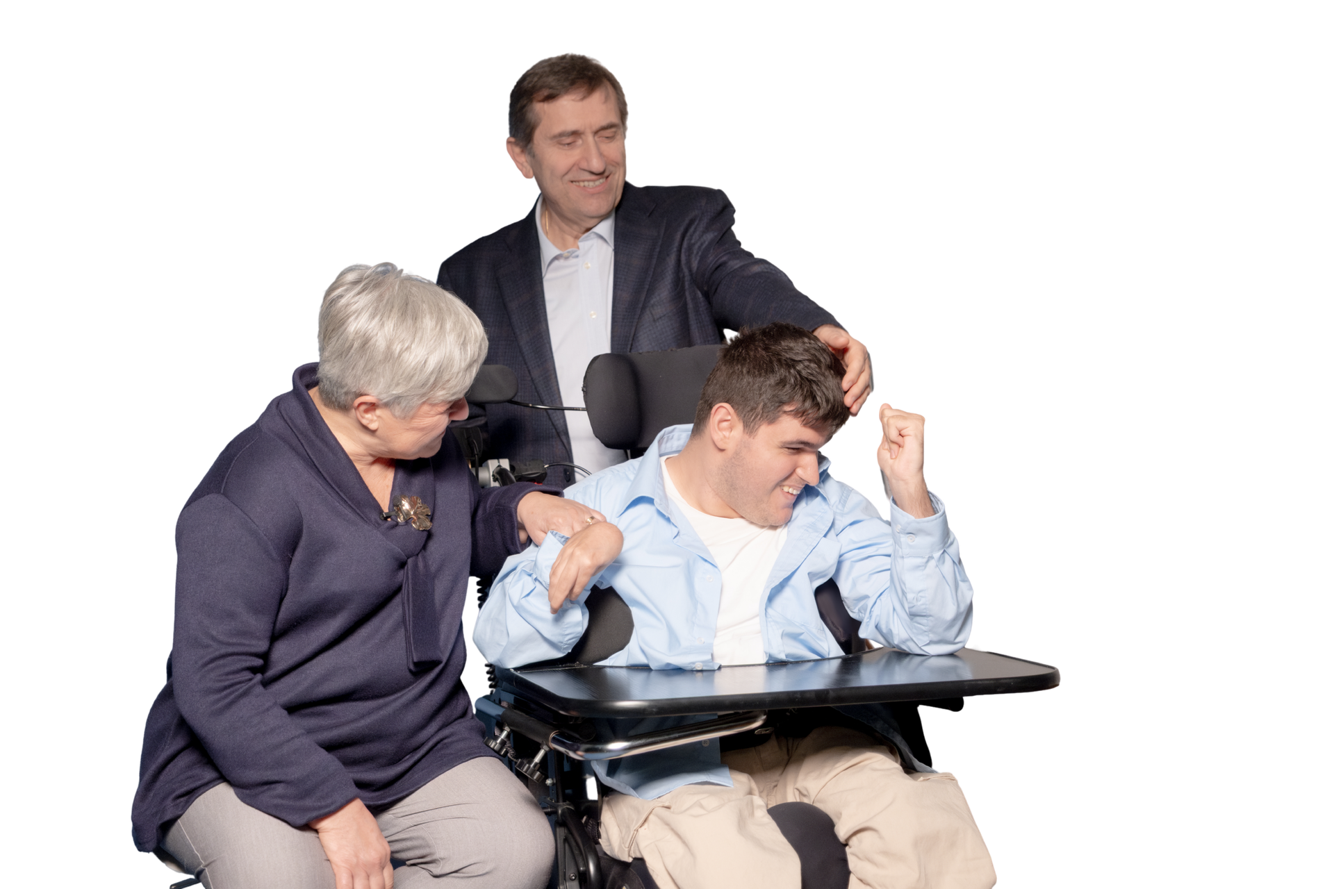 Antonio è seduto sulla sua sedia a rotelle e ride. Alla sua destra, la mamma ride insieme a lui e gli tiene il braccio. Dietro il papà che gli fa una carezza sui capelli