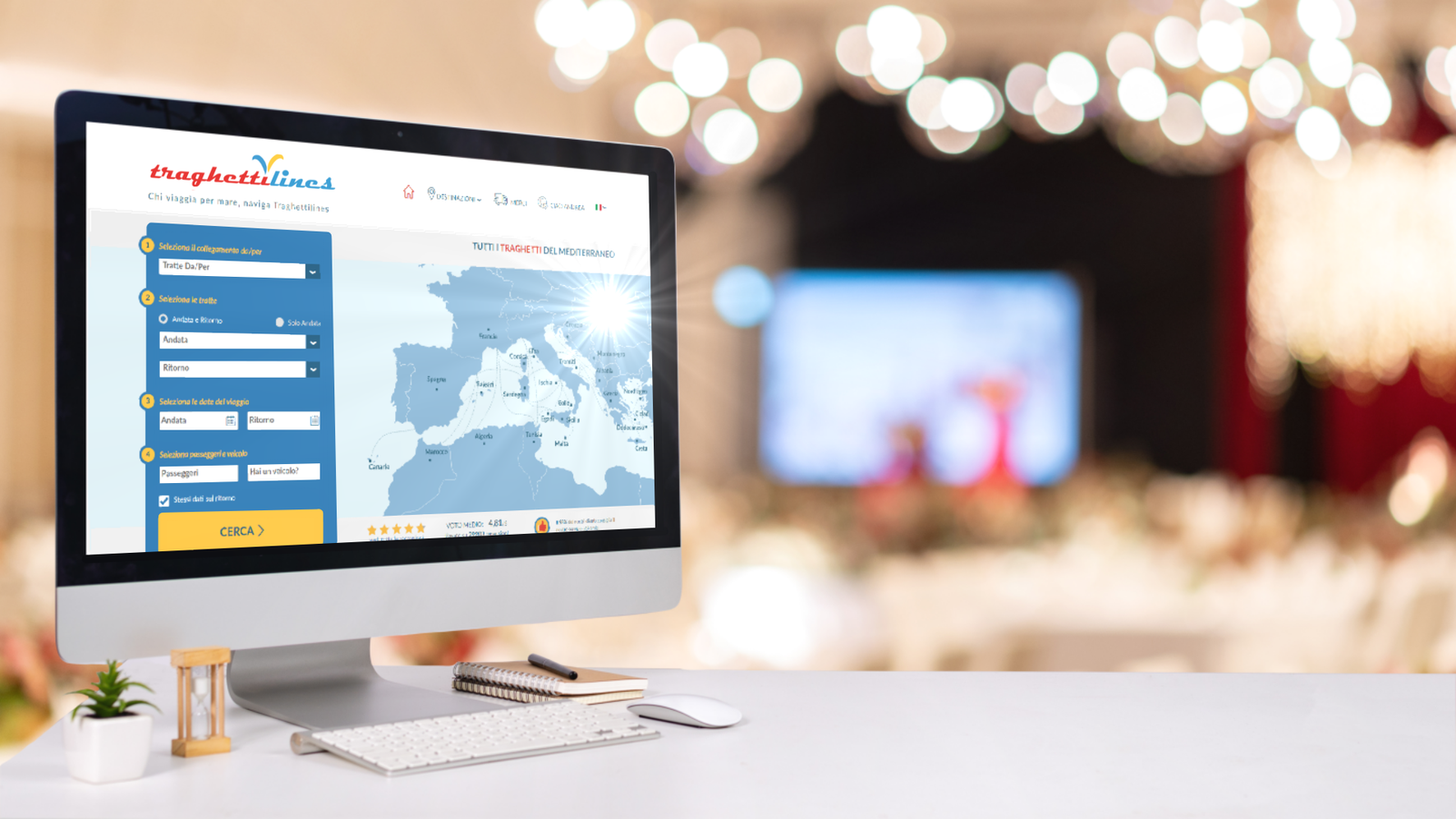 Su una scrivania ordinata è visibile lo schermo di un computer che mostra la homepage del sito TraghettiLines. L’immagine è stata creata per promuovere la partnership con la Lega del Filo d'Oro.