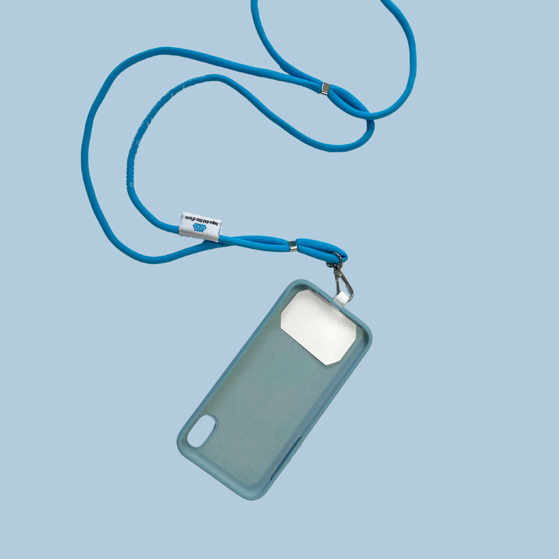 La foto mostra come infilare la linguetta bianca all'interno della cover del proprio smarthone in modo da agganciarci poi correttamente il laccetto per Smartphone della Lega del Filo d'Oro